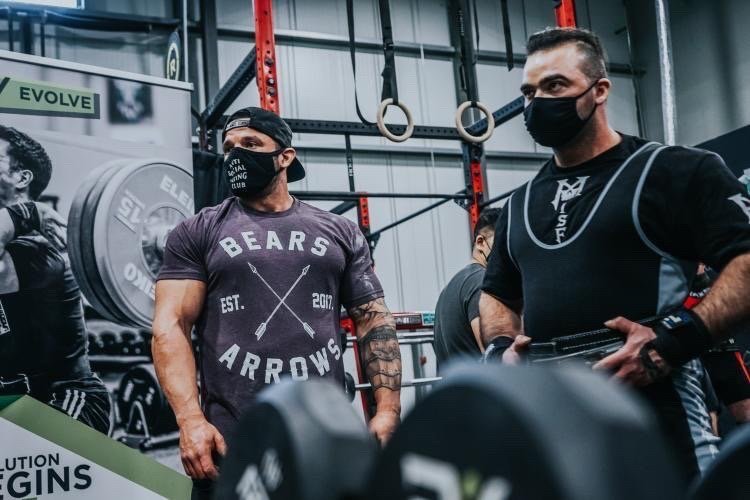 Paul (left) preparing his athlete to squat at ShellShock powerlifting meet. (Edmonton, Alberta, Canada)